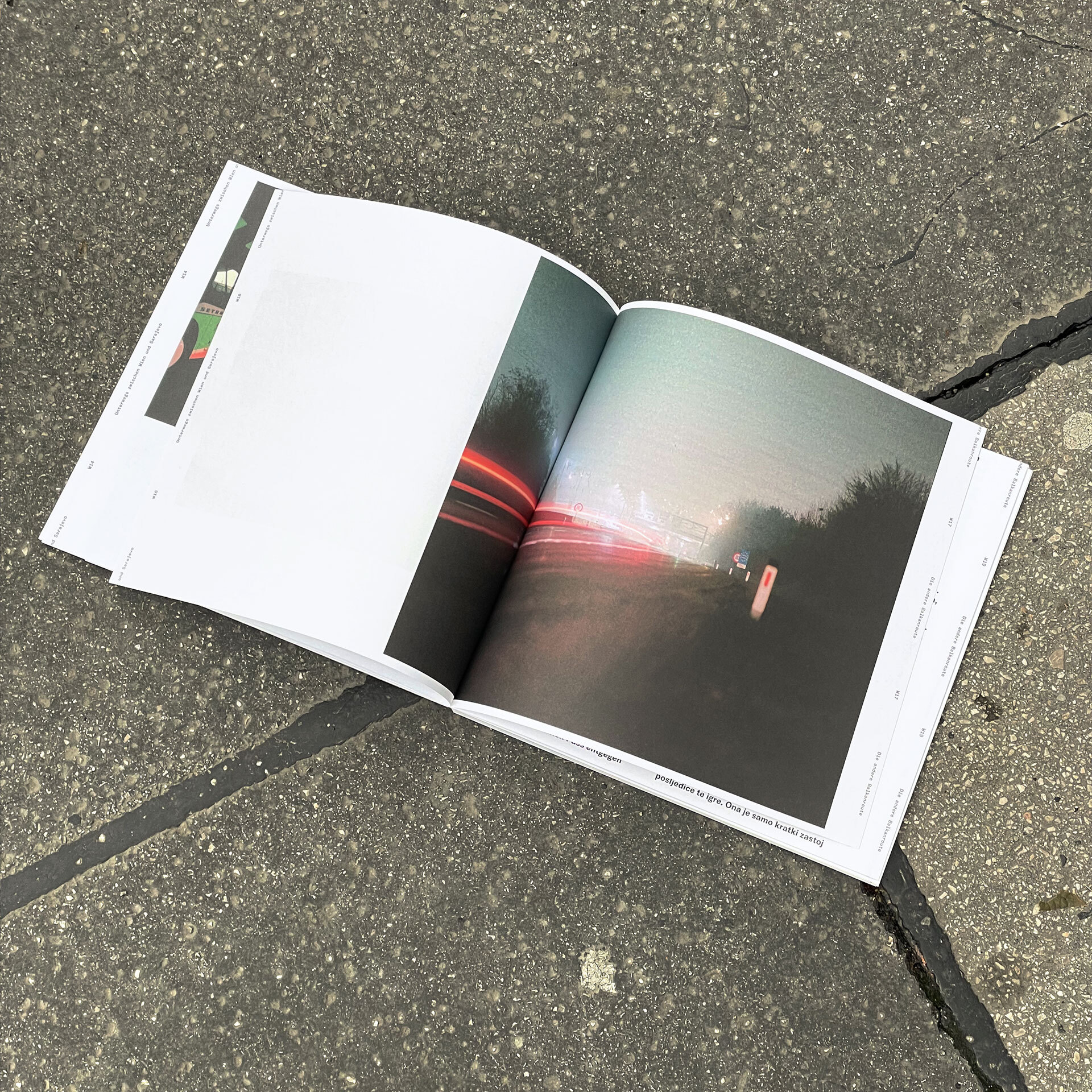 book lying on asphalt floor, print